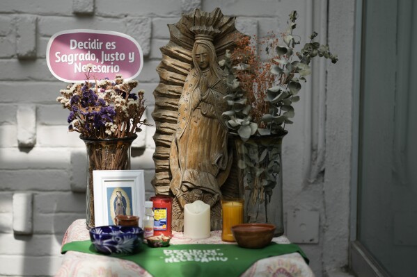 A green scarf with a message that reads in Spanish: “To decide is sacred, just and necessary” adorns an altar to the Virgin Mary, in the office of the Catholics for the Right to Decide, in Mexico City, Monday, Dec. 4, 2023. Members of the organization denounce the invisibility of women in some religious environments and advocate for the reinterpretation of sacred texts with a feminist perspective. (AP Photo/Eduardo Verdugo)
