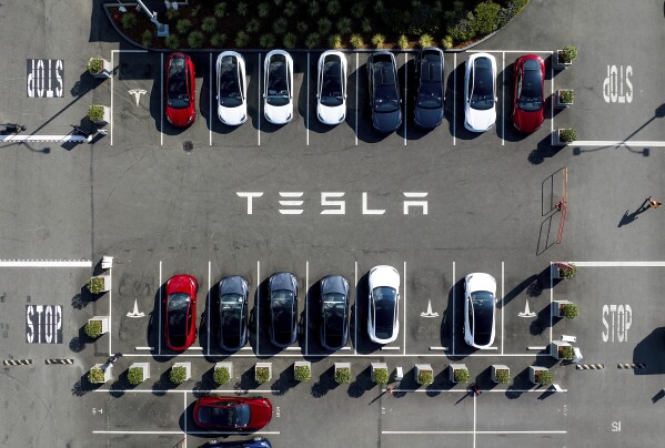 FILE - Tesla vehicles line a parking lot at the company's Fremont, Calif., factory, on Sept. 18, 2023. Tesla is recalling more than 2 million vehicles across its model lineup to fix a defective system that's supposed to ensure drivers are paying attention when they use Autopilot. (AP Photo/Noah Berger, File)
