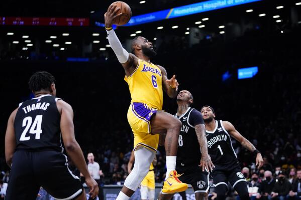 Los Angeles Lakers' LeBron James (6) drives past Brooklyn Nets' James Johnson (16) as Cam Thomas (24) watches during the first half of an NBA basketball game Tuesday, Jan. 25, 2022 in New York. (AP Photo/Frank Franklin II)