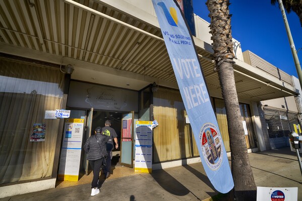 Voters arrive at the Latin Paradise Banquet Hall to cast their ballot on Super Tuesday, in the Van Nuys section of Los Angeles, Tuesday, March 5, 2024.  (AP Photo/Richard Vogel)