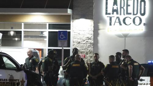 Broward Sheriff's Office Deputies work the scene of a shooting in Dania Beach, Fla., Friday, May 5, 2023. A man fatally shot a 12-year-old boy and wounded another man before turning the gun on himself inside a South Florida gas station, sheriff's officials said Friday.(Joe Cavaretta/South Florida Sun-Sentinel via AP)