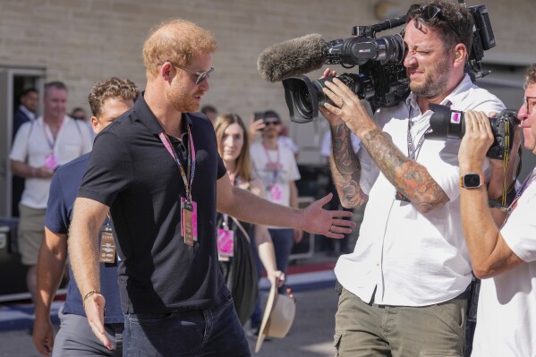 FILE - Prince Harry, The Duke of Sussex, conducts an interview during the Formula One U.S. Grand Prix auto race at Circuit of the Americas, on Oct. 22, 2023, in Austin, Texas. Prince Harry is appealing to the British government to turn over evidence that is key to his phone hacking lawsuit against the publisher of the Daily Mail. An attorney for the Duke of Sussex said Tuesday, Nov. 21, 2023, he would ask government ministers to lift restrictions that were imposed by an inquiry more than a decade ago into a widespread scandal involving journalists eavesdropping on voicemails of celebrities, politicians and even murder victims.(AP Photo/Nick Didlick)