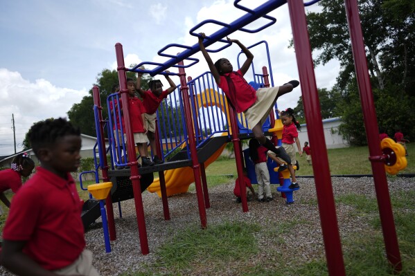 FILE - Students from Thomas Leadership Academy play on the school's playground in Eatonville, Fla., Aug. 23, 2023. Seventy years after the Supreme Court's Brown v. Board, America is both more diverse — and more segregated. (AP Photo/Rebecca Blackwell, File)