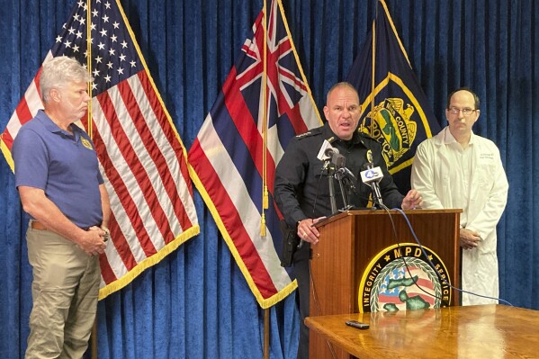 Defense POW/MIA Account Agency Laboratory Director John Byrd, left, Maui Police Chief John Pelletier, center, and Maui County Physician's Coroner Dr. Jeremy Stuelpnagel talk about a drop in the estimated number of deaths from a deadly August wildfire during a press conference in Wailuku, Hawaii, on Friday Sept. 15, 2023. Authorities now believe that at least 97 people died in the Lahaina wildfire, a decrease from the previous estimate of 115. (AP Photo/ Jennifer Sinco Kelleher)