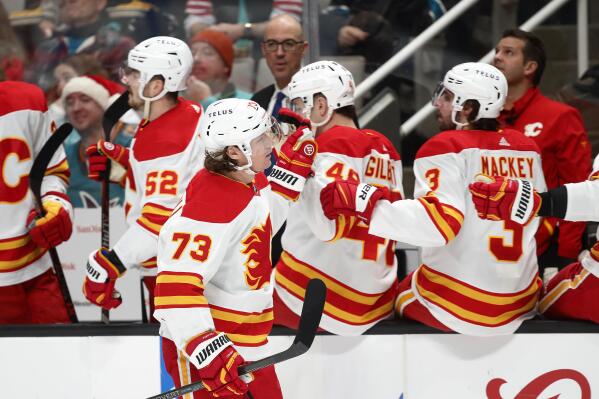 Calgary Flames right wing Tyler Toffoli (73) celebrates with the bench after scoring a goal in the first period of an NHL hockey game against the San Jose Sharks, Sunday, Dec. 18, 2022, in San Jose, Calif. (AP Photo/Josie Lepe)