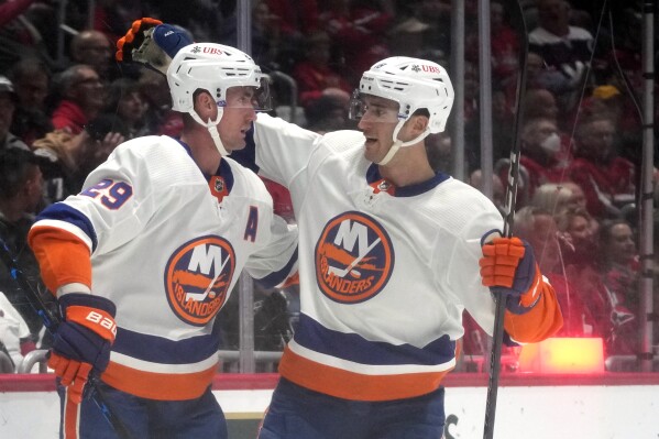 New York Islanders center Brock Nelson (29), left, is congratulated by left wing Pierre Engvall, right, after scoring in the second period of an NHL hockey game against the Washington Capitals, Thursday, Nov. 2, 2023, in Washington. (AP Photo/Mark Schiefelbein)