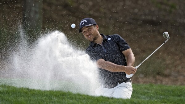 Xander Schauffele blasts from the sand on the eighth hole during the third round of The Players Championship golf tournament Saturday, March 16, 2024, in Ponte Vedra Beach, Fla. (AP Photo/Lynne Sladky)