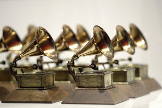 FILE - In this Oct. 10, 2017, file photo, various Grammy Awards are displayed at the Grammy Museum Experience at Prudential Center in Newark, N.J. The academy, which puts on the 62nd Grammys on Sunday, Jan. 26, 2020, says nominees are selected from a list of contenders who are voted into the top 20 in each category. But some people view the voting process as less than transparent, since the choice of finalists happens behind closed doors. (AP Photo/Julio Cortez, File)
