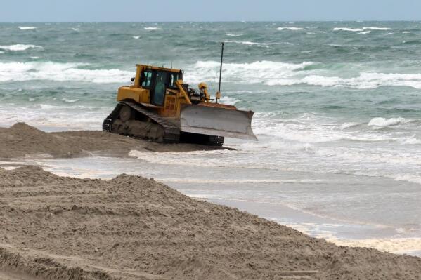 A bulldozer smooths out newly placed sand on an eroded beach in North Wildwood, N.J. on Tuesday, May 24, 2022. Winter and spring storms caused erosion that will prevent several Jersey Shore beaches from being ready for Memorial Day weekend, but the vast majority of the state's beaches came through the off-season in good condition. (AP Photo/Wayne Parry)
