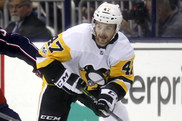 FILE - Pittsburgh Penguins forward Adam Johnson in action during an NHL hockey game in Columbus, Ohio, Friday, Sept. 22, 2017. Police in England arrested a man Tuesday, Nov. 14, 2023, on suspicion of manslaughter in the death of American ice hockey player Adam Johnson, whose neck was cut by a skate during a game. (AP Photo/Paul Vernon, File)