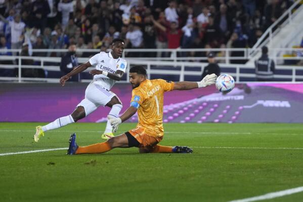 Real Madrid's Vinicius Junior scores the opening goal past Al Hilal goalkeeper Abdullah Al-Mayouf during the FIFA Club World Cup final match between Real Madrid and Al Hilal at Prince Moulay Abdellah stadium in Rabat, Morocco, Saturday, Feb. 11, 2023. (AP Photo/Manu Fernandez)