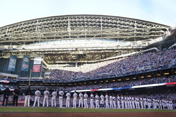 The Arizona Diamondbacks line up for Game 3 of the baseball World Series against the Texas Rangers Monday, Oct. 30, 2023, in Phoenix. (AP Photo/Godofredo A. Vásquez)