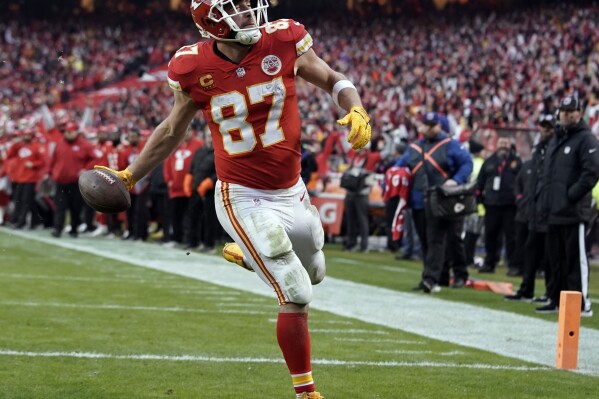 FILE. - Kansas City Chiefs tight end Travis Kelce scores a touchdown against the Jacksonville Jaguars during an NFL Divisional Playoff football game Jan. 21, 2023, in Kansas City, Mo. Kelce has shattered numerous records over his 10-year career and was the unanimous choice by The Associated Press for the top spot among tight ends. (AP Photo/Ed Zurga, File)