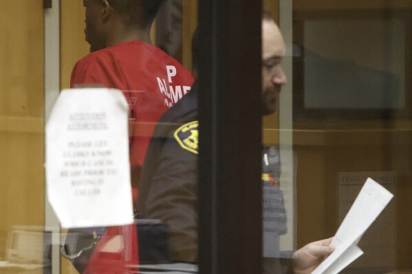 Mark Sanders, left, appears at the Wiley W. Manuel Courthouse in Oakland, Calif., Thursday, Jan. 4, 2024. Sanders, 27, of Tracy, Calif., and Allen Starr Brown, 28, of Chico, Calif., were charged with murder Wednesday, Jan. 4, 2023, in the death of an Oakland police officer who was shot while answering a burglary report at a marijuana business, authorities said. (Aric Crabb/Bay Area News Group via AP)