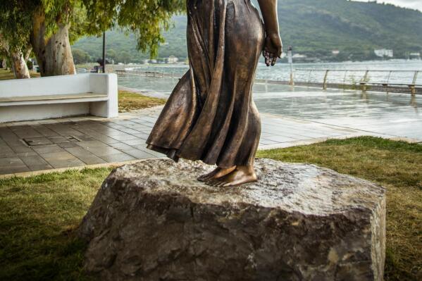 The bronze sculpture of the "Spigolatrice di Sapri" in Sapri, Italy, Thursday, Sept. 30, 2021. An artist is defending his sculpture of a 19th century peasant woman against charges of sexism after its recent unveiling sparked outrage among some Italian lawmakers and art critics who said she looked more like a starlet than a peasant. The bronze sculpture of the “Spigolatrice di Sapri” – based on a famous Italian poem by the same name about a woman who gathers wheat - was unveiled during a Sept. 25 waterfront ceremony in Sapri, southern Italy, in the presence of local officials and former Premier Giuseppe Conte. (Valentino Palermo via AP)