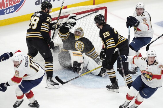 Florida Panthers' Evan Rodrigues (17) celebrates his goal near Anton Lundell (15) and Vladimir Tarasenko (10) as Boston Bruins' Derek Forbort (28) and Brandon Carlo (25) look toward goalie Jeremy Swayman, center, during the first period in Game 3 of an NHL hockey Stanley Cup second-round playoff series Friday, May 10, 2024, in Boston. (AP Photo/Michael Dwyer)