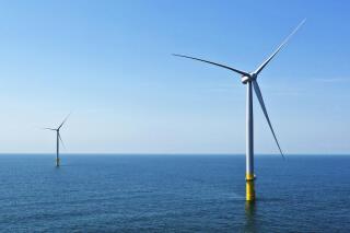 FILE - Two of the offshore wind turbines, which have been constructed off the coast of Virginia Beach, Va., are seen, June 29, 2020. Virginia regulators granted a critical approval Thursday, Dec. 15, 2022, for Dominion Energy's plans to construct and operate a 176-turbine wind farm in the Atlantic Ocean. (AP Photo/Steve Helber, File)