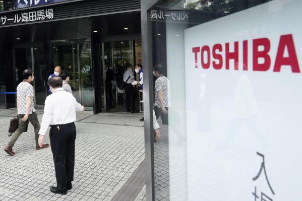 Shareholders arrive for Toshiba's general meeting of shareholders in Tokyo Friday, June 25, 2021. Battered Japanese nuclear and electronics giant Toshiba Corp. faced off with shareholders Friday, seeking to shake off serious questions about governance at the once revered brand. (Katsuya Miyagawa/Kyodo News via AP)