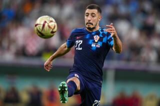 FILE - Croatia's Josip Juranovic attempts to control the ball during the World Cup semifinal soccer match between Argentina and Croatia at the Lusail Stadium in Lusail, Qatar, on Dec. 13, 2022. Union Berlin has signed Croatia right back Josip Juranovic from Scottish team Celtic for the modest Bundesliga club’s biggest transfer to date. Union announced the 27-year-old Juranović’s transfer on Sunday, without giving details of the length of his contract or transfer fee. (AP Photo/Petr David Josek, File)