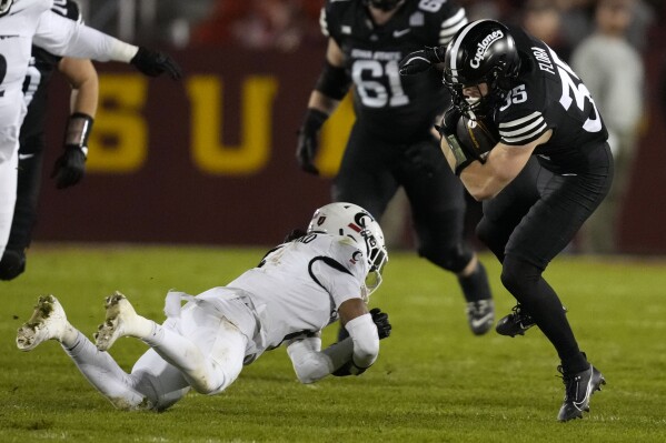 Iowa State running back Aiden Flora (35) breaks a tackle by Cincinnati safety Trevon Gola-Callard during the first half of an NCAA college football game, Saturday, Nov. 16, 2024, in Ames, Iowa. (AP Photo/Charlie Neibergall)