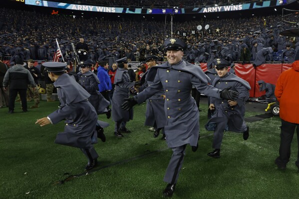 Army Cadets storm the field after defeating Navy in an NCAA college football game at Gillette Stadium Saturday, Dec. 9, 2023, in Foxborough, Mass. (AP Photo/Winslow Townson)