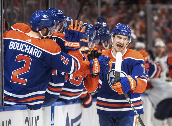 Edmonton Oilers' Ryan McLeod (71) is congratulated for a goal against the Florida Panthers during the third period of Game 6 of the NHL hockey Stanley Cup Final, Friday, June 21, 2024, in Edmonton, Alberta. The Oilers won 5-1 to tie the series. (Jason Franson/The Canadian Press via AP)