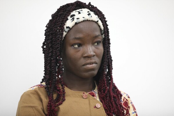Amina Ali, one of the Chibok schoolgirls who was kidnapped in 2014 by Islamic extremists and later escaped, attends a 10th anniversary event of the abduction in Lagos, Nigeria, Thursday, April 4, 2024. A new film in Nigeria is being screened to remember the nearly 100 schoolgirls who are still in captivity 10 years after they were seized from their school in the country’s northeast. At least 276 girls were kidnapped during the April 2014 attack that stunned the world, but most have since regained their freedom. (AP Photo/Mansur Ibrahim )
