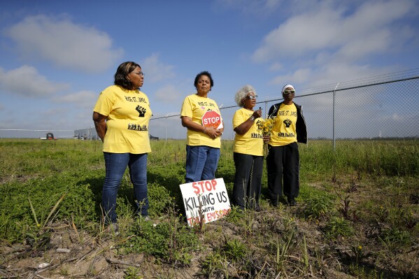 FILE - Myrtle Felton, from left, Sharon Lavigne, Gail LeBoeuf and Rita Cooper, members of RISE St. James, conduct a live stream video on property owned by Formosa on March 11, 2020, in St. James Parish, La. The Biden administration has dropped an investigation into whether Louisiana officials put Black residents living in an industrial stretch of the state at increased cancer risk, despite finding initial evidence of racial discrimination, according to a federal court filing Tuesday, June 27, 2023. (AP Photo/Gerald Herbert, File)