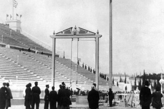 FILE - This April 10, 1896, file photo, shows Greek athlete Nikolaos Andriakopoulos on his way to winning the gold medal in the rope climbing event at the first modern Summer Olympic Games held at the Panathinaiko Stadium in Athens, Greece. (AP Photo/File)