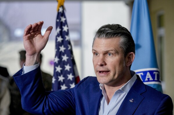 US Secretary of Defense Pete Hegseth talks to the media during his visit to the headquarters of U.S. European Command and Africa Command in Stuttgart Germany, Tuesday, Feb. 11, 2025. (AP Photo/Michael Probst)