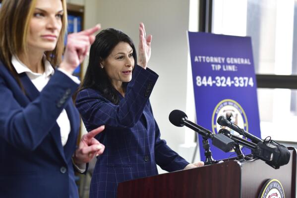 Michigan Attorney General Dana Nessel announces charges against Mark Chapman, a former Boy Scout troop leader, on Wednesday, March 9, 2022, in Detroit. Chapman, 51, is accused of sexually assaulting two boys at the time he was a scoutmaster in the Detroit suburb of Roseville, where he also worked in and attended The Church of Jesus Christ of Latter-day Saints. The charge stem from the state's review of child sexual abuse lawsuits against the Boy Scouts of America. (Max Ortiz/Detroit News via AP)