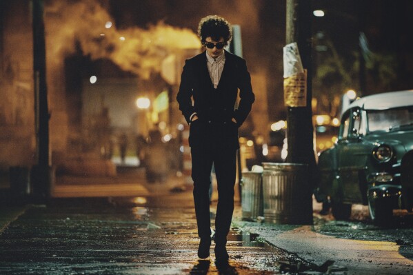 This image released by Searchlight Pictures shows Timothée Chalamet in a scene from "A Complete Unknown." (Macall Polay/Searchlight Pictures via AP)