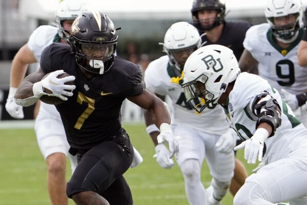 Central Florida running back RJ Harvey (7) looks for room to run against the Baylor defense during the first half of an NCAA college football game, Saturday, Sept. 30, 2023, in Orlando, Fla. (AP Photo/John Raoux)