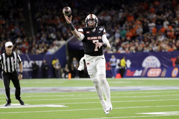 Oklahoma State quarterback Alan Bowman jumps to pass the ball against Texas A&M during the first half of the Texas Bowl NCAA college football game Wednesday, Dec. 27, 2023, in Houston. (AP Photo/Michael Wyke)
