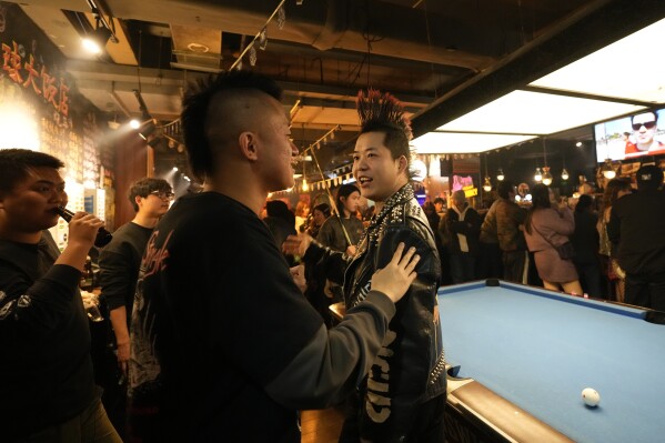 Chinese punks talk at a bar during a punk festival in Hangzhou, China, Friday, Jan. 17, 2025. (AP Photo/Aaron Favila)