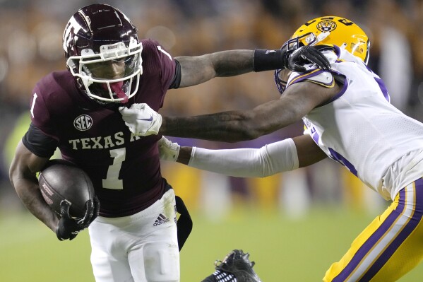 FILE -Texas A&M wide receiver Evan Stewart (1) fights off LSU safety Jay Ward (5) for a seven yard gain during the first quarter of an NCAA college football game Saturday, Nov. 26, 2022, in College Station, Texas. Texas A&M receiver Evan Stewart is the latest member of the Aggies’ top-ranked recruiting class from 2022 to enter the transfer portal. (AP Photo/Sam Craft, File)