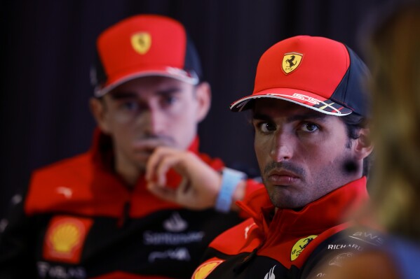 FILE - Ferrari driver Carlos Sainz, of Spain, right, accompanied by teammate Charles Leclerc, of Monaco, attends a press conference in Sao Paulo, Brazil, on Nov. 9, 2022. Carlos Sainz Jr. believes he has “plenty of options” in Formula 1 next year when he leaves Ferrari to make way for Lewis Hamilton, the Spaniard said Tuesday, Feb. 13, 2024. (AP Photo/Marcelo Chello, File)