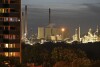 FILE - The coal-fired power plant Uniper Scholven and a nearby BP refinery shine in the evening behind illuminated appartments in Gelsenkirchen, Germany, Monday, Oct. 2, 2023. Environmental activists say the lobbying of fossil fuel interests are the reason why climate talks have yet to produce an agreement to phase out coal, oil and natural gas, as scientists have repeatedly said must happen to stave off the worst impacts of climate change, like extreme weather events. (AP Photo/Martin Meissner, File)