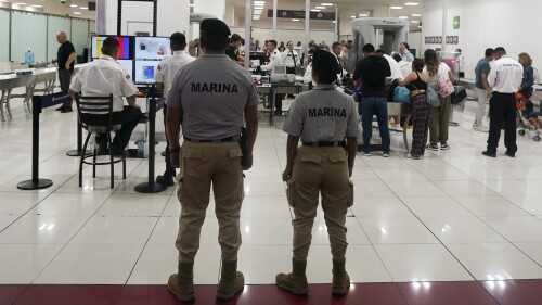 FILE - A Mexican Navy officer stands guard next to a security checkpoint at Mexico City's Benito Juárez International Airport on Friday, June 30, 2023. Mexican forces have seized control of the capital's main airport, and the government plans to allow the military to take control, adding a dozen more across the country as the president seeks corruption and misgovernment.  (AP Photo/Fernando Llano, File)
