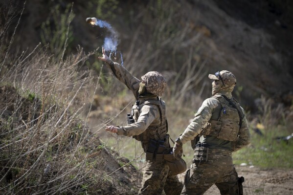 Members of the Siberian Battalion, which was formed mostly of volunteer Russian citizens, of the Ukrainian Armed Forces' International Legion, practice during military exercises, amid Russia's attack on Ukraine, at an undisclosed location in Kyiv region, Ukraine, Wednesday, April 10, 2024. (AP Photo/Efrem Lukatsky)