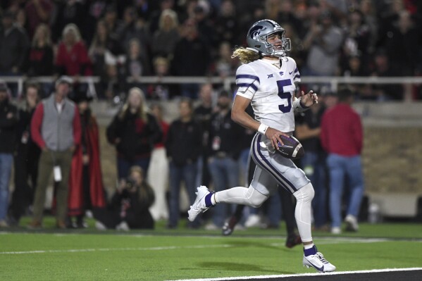 Kansas State quarterback Avery Johnson (5) scores a touchdown against Texas Tech during an NCAA college football game, Saturday, Oct. 14, 2023, in Lubbock, Texas. (Annie Rice/Lubbock Avalanche-Journal via AP)