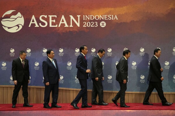 From left to right, Thailand's Permanent Secretary of the Ministry of Foreign Affairs Sarun Charoensuwan, Vietnam's Prime Minister Pham Minh Chinh, Indonesian President Joko Widodo, Laotian Prime Minister Sonexay Siphandone, Brunei's Sultan Hassanal Bolkiah and Cambodia's Prime Minister Hun Manet leave the stage after a group photo before the start of the retreat session at the Association of Southeast Asian Nations (ASEAN) Summit in Jakarta, Indonesia, Tuesday, Sept. 5, 2023. (AP Photo/Achmad Ibrahim, Pool)