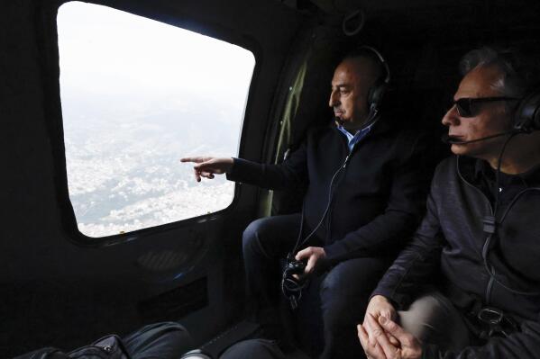 U.S. Secretary of State Antony Blinken, right, and Turkish Foreign Minister Mevlut Cavusoglu sit in a helicopter for a tour of earthquake stricken areas, in Turkey, Sunday, Feb. 19, 2023. (Clodagh Kilcoyne/Pool Photo via AP)