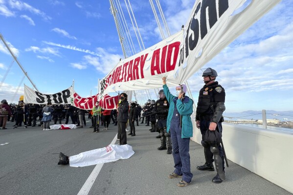 FILE - Demonstrators shut down the San Francisco Oakland Bay Bridge in conjunction with the APEC Summit taking place Thursday, Nov. 16, 2023, in San Francisco. San Francisco's District Attorney's Office on Monday began charging demonstrators who blocked traffic for hours last month on the Bay Bridge to demand a cease-fire in Gaza. (AP Photo/Noah Berger, File)