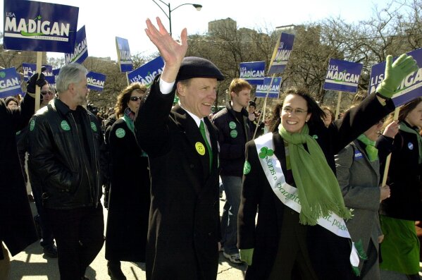FILE - In this March 16, 2002 file photo, Illinois Democratic Attorney General candidate Lisa Madigan, right, walks in the St. Patrick's Day parade with her father, then Illinois House Speaker Michael Madigan, left, in Chicago. State Rep. Madigan, a Chicago Democrat who virtually set Illinois' political agenda as House speaker before he was ousted last month, announced Thursday, Feb. 18, 2021, that he is resigning his seat in the Legislature. (AP Photo/Stephen J. Carrera File)