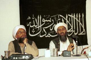 FILE - In this 1998 file photo made available Friday, March 19, 2004, Ayman al-Zawahri, left, listens during a news conference with Osama bin Laden in Khost, Afghanistan. A U.S. airstrike has killed al-Qaida leader Ayman al-Zawahri in Afghanistan, according to a person familiar with the matter. President Joe Biden will speak about the operation on Monday night, Aug. 1, 2022, from the White House. (AP Photo/Mazhar Ali Khan, File)