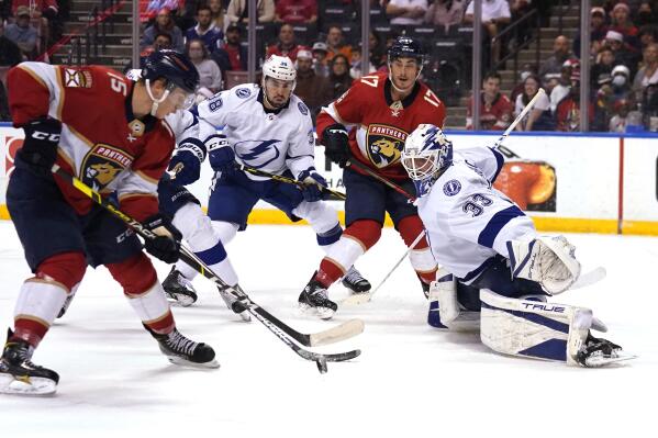 Tampa Bay Lightning goaltender Maxime Lagace (33) defends the goal as Florida Panthers center Anton Lundell (15) prepares to shoot for a goal during the second period of an NHL hockey game, Thursday, Dec. 30, 2021, in Sunrise, Fla. (AP Photo/Lynne Sladky)