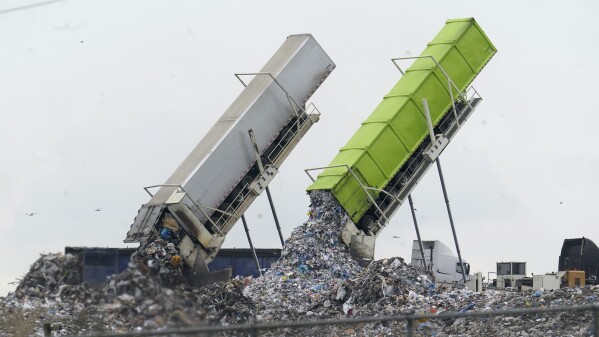 FILE - Garbage is loaded into a landfill in Lenox Township, Mich., July 28, 2022. A new United Nations report estimates that 19% of the food produced around the world went to waste in 2022. (AP Photo/Paul Sancya, File)