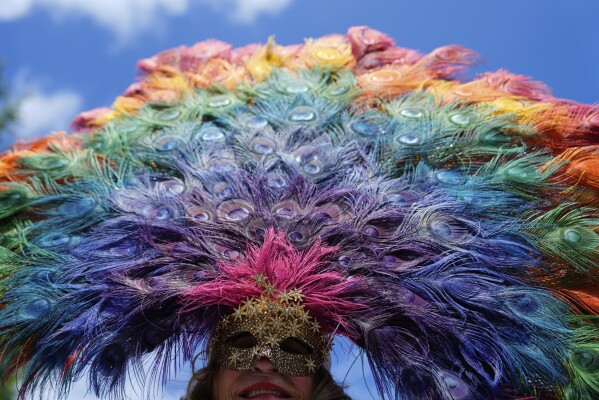 A person wearing a mask is pictured before the World Pride parade, Saturday, June 7, 2025, in Washington. (AP Photo/Julia Demaree Nikhinson)