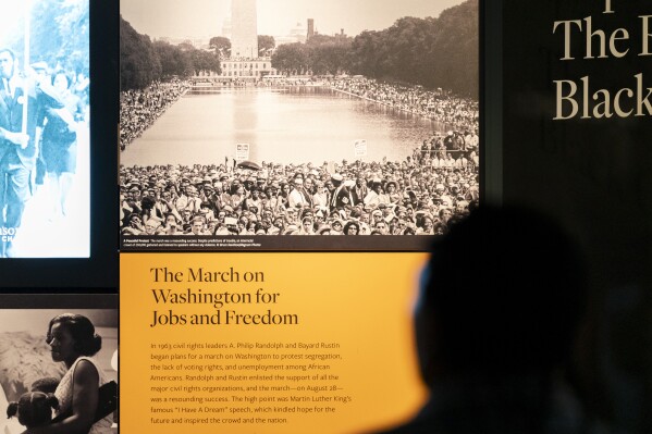 A visitor reads a display about the 1963 March on Washington for Jobs and Freedom at the National Museum of African American History and Culture in Washington, Friday, Aug. 18, 2023. (AP Photo/Stephanie Scarbrough)